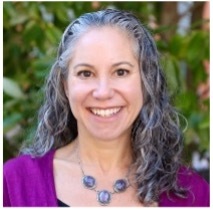 Naomi Goldstein smiling, standing outdoors.