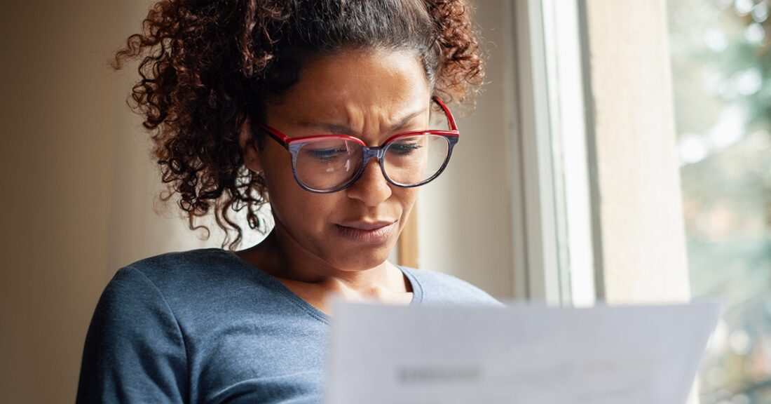 Woman looks at a document.