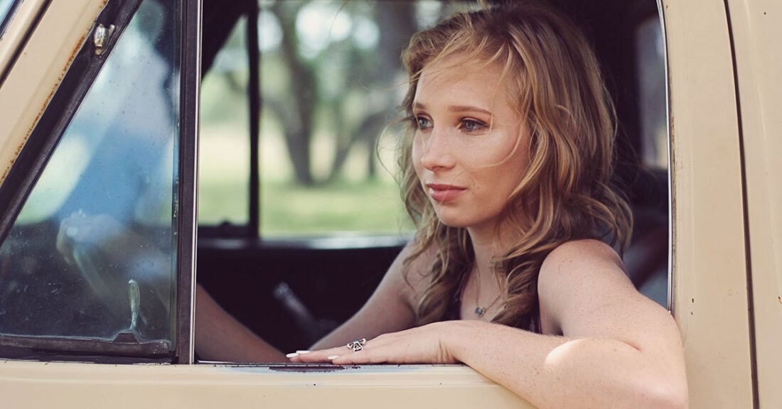 Young woman behind the wheel of a pickup truck