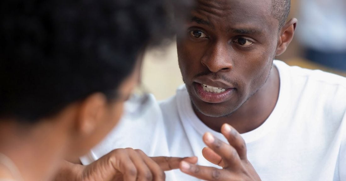 A Black mentor offers advice to a young man.