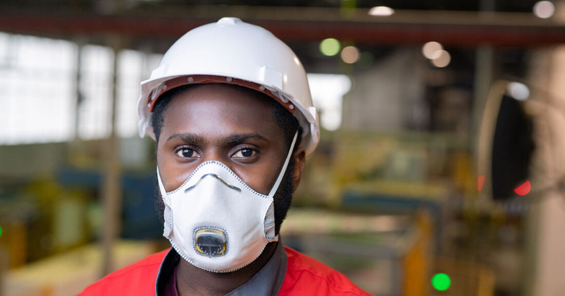 Young person working while wearing a face mask