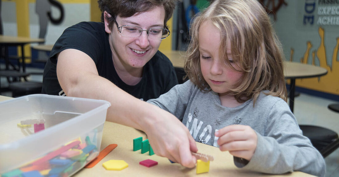 Classroom worker helps a child