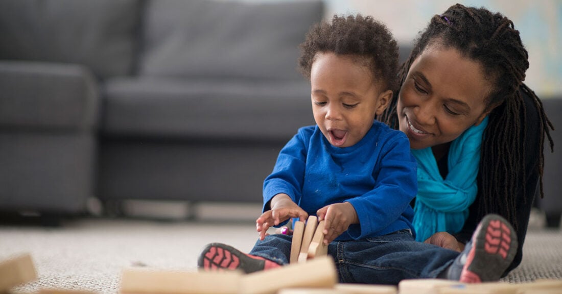 Mom and toddler play on the floor