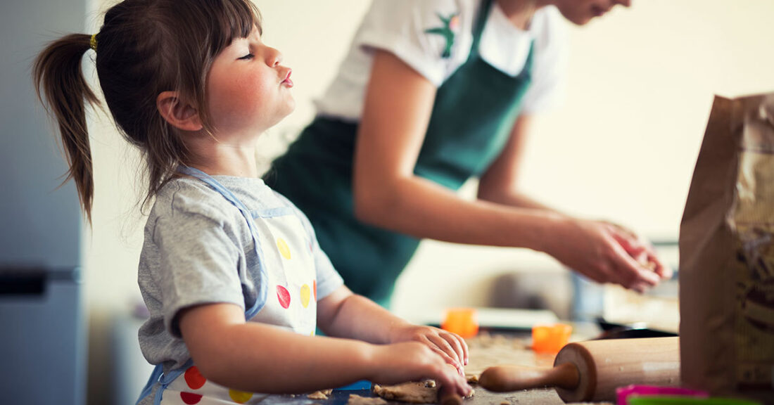 Young parent bakes with child