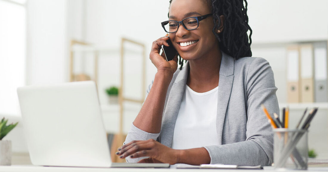 Woman talking on phone in a professional setting