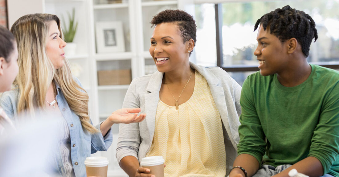 A parent and child participate in a Team Decision Making meeting with child welfare officials.