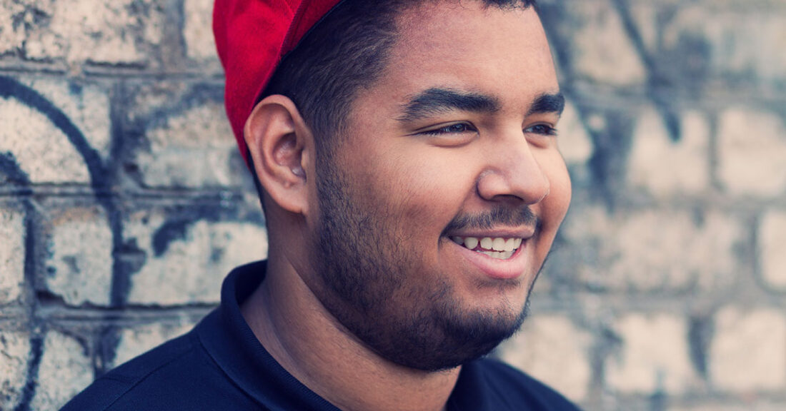 Young black male with red cap