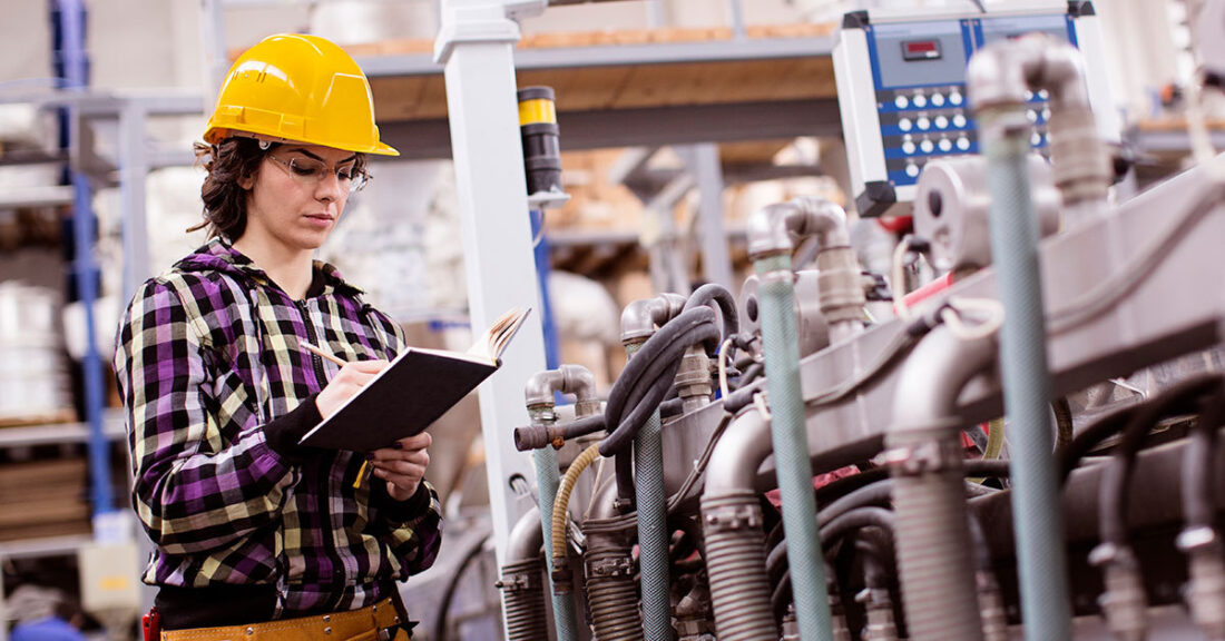 A young woman working in a production facility.