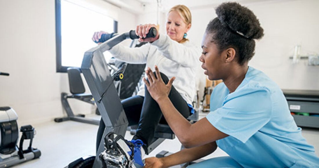 African-American occupational therapist works with patient