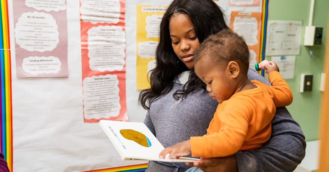 Mom holds baby in classroom setting