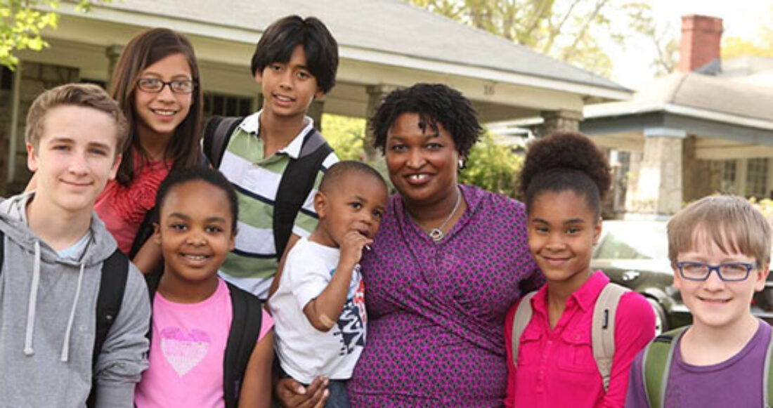 Stacey Abrams surrounded by children