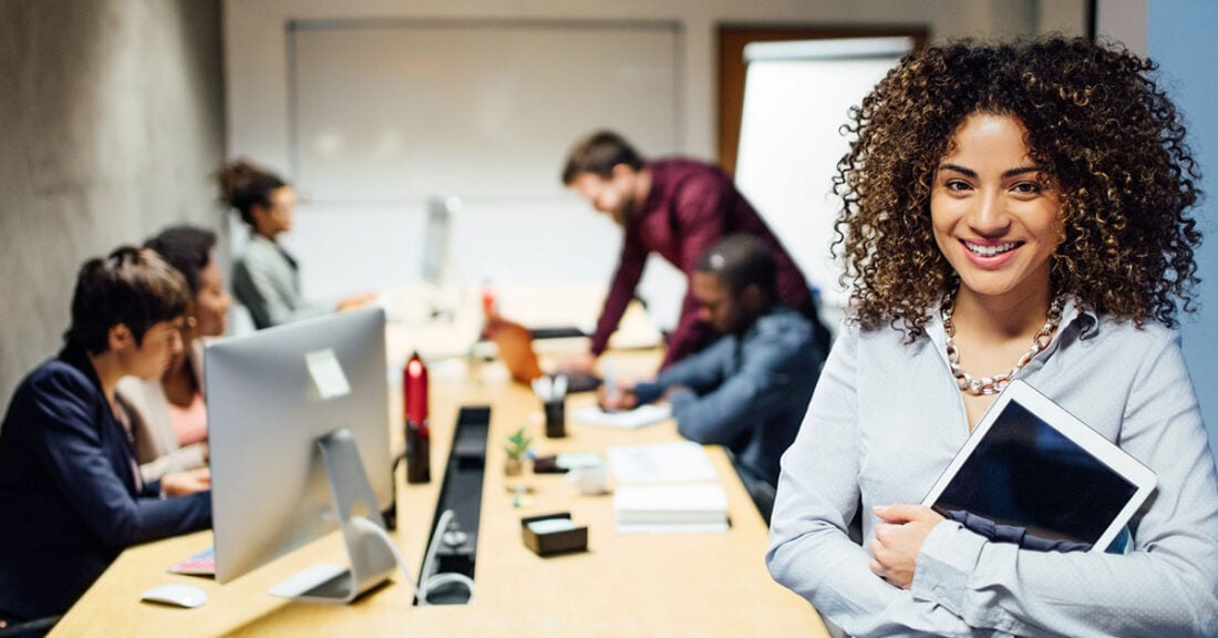 Young person at work with colleagues