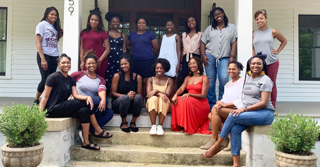 Group of Black girls and women on steps of house