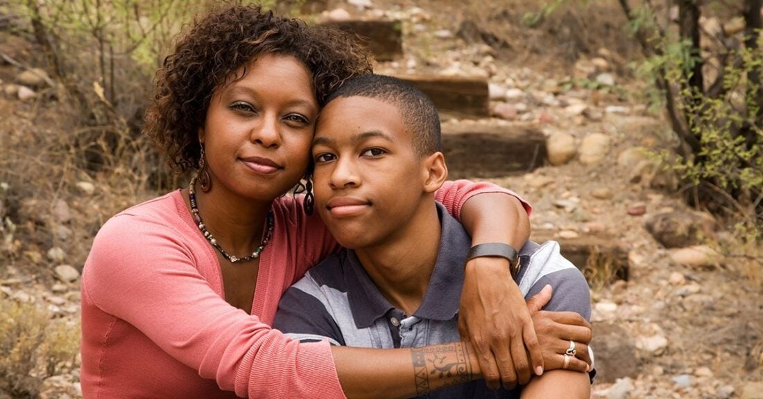 Mother with her arms around her teen son