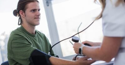 Young man gets his blood pressure checked.