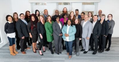 A group photo of participants in the Casey Foundation’s Juvenile Justice Applied Leadership Network, standing together and smiling in a bright indoor setting.