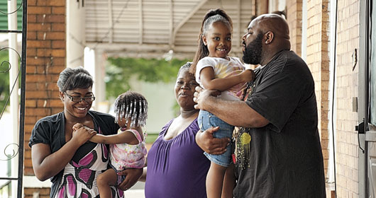 Tarsha Mitchell, Warren Matthews and daughters Shaw’dae, 16, Tekiyah and Mekaylah in front of their Baltimore home.