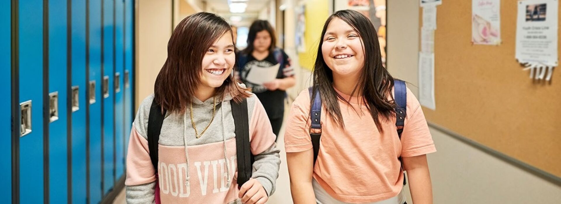 Two Native American children in school hallway