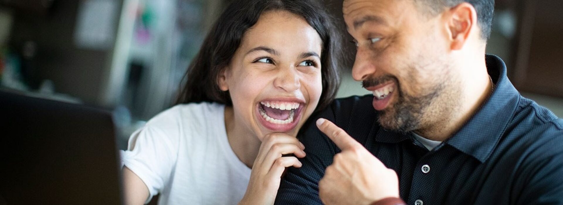 Teenage daughter laughs with father