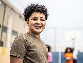 Portrait of a boy of color at a basketball court